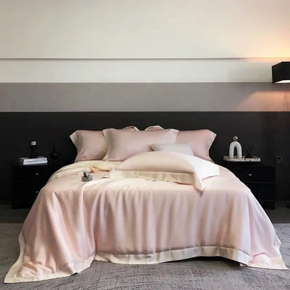 A soft blush pink satin duvet cover bedding set made from lyocell eucalyptus fiber elegantly draped over a bed