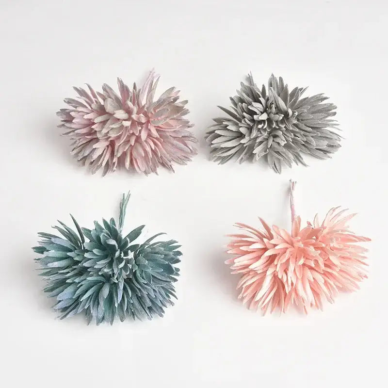 Four pastel pink gray and blue green silk mini handmade flowers with layered spiky petals in a mini handmade bouquet
