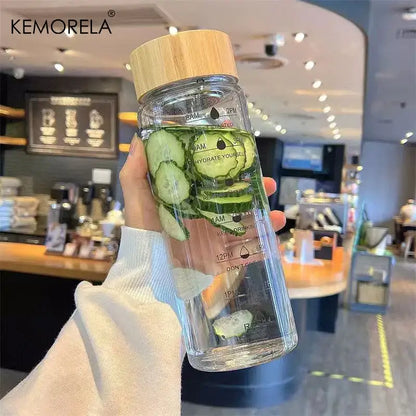Decorbites 700ml glass water bottle with natural wood lid, time marker, cucumber infusion, and stainless steel tea filter