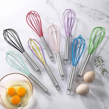 Set of colorful stainless steel silicone whisk mixers with 8-inch handles arranged on marble for baking and cooking