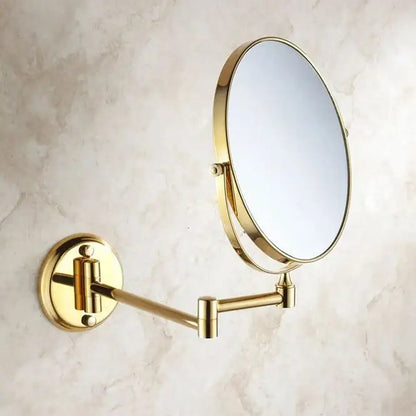 Gold-finished brass dual makeup mirror with 8 inch round glass and sleek articulated arm for wall mounting