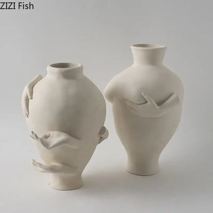 Cream-colored decorbites abstract art ceramic vase featuring sculpted human forms and hands for desk decoration