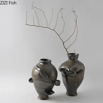 Two dark metallic ceramic vases with hand-like sculpted appendages from decorbites abstract art ceramic vase collection