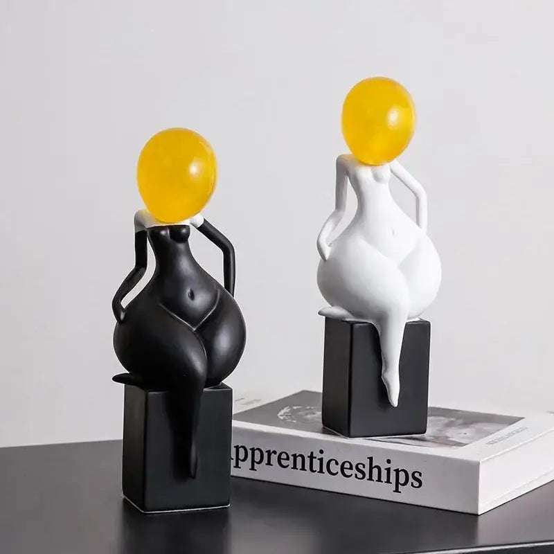 Two resin female body decorbites abstract art figurines in black and white with smooth yellow balloon heads for home decor