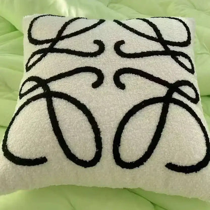 White textured cushion cover with bold black embroidered decorbites abstract art line logo plush pillowcase