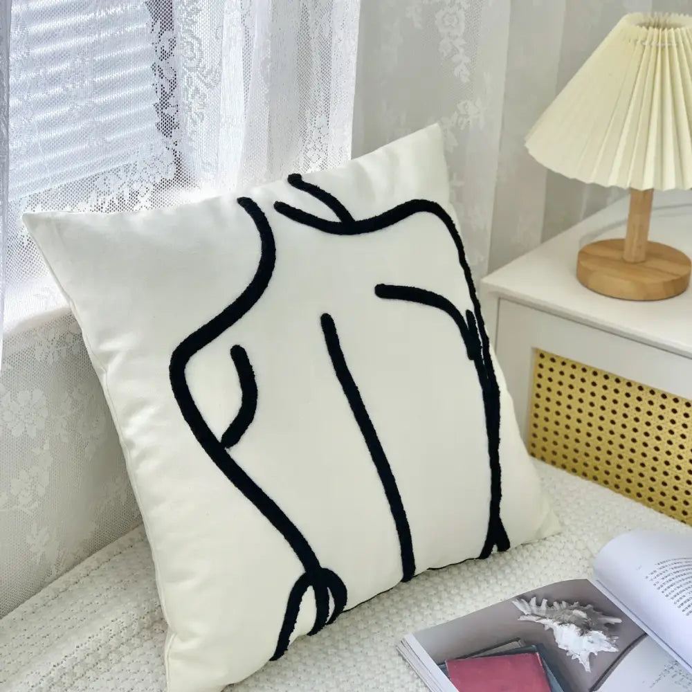 White cushion cover with black embroidered abstract human silhouette in decorbites abstract art line design