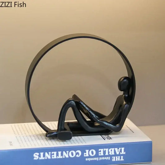 Black minimalist abstract black characters resin sculpture of seated figure with circular frame for desk decor