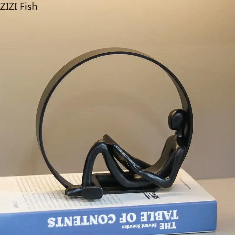 Black minimalist abstract black characters resin sculpture of seated figure with circular frame for desk decor