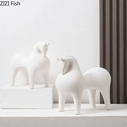 Two minimalist white glossy decorative figurines of abstract ceramic horse sculptures by DecorBites™