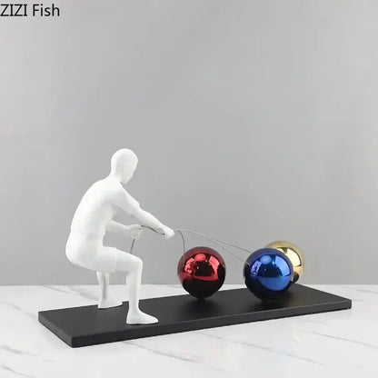 White resin decorbites abstract character figurine pulling red blue and gold spheres in metal sculpture desk ornament