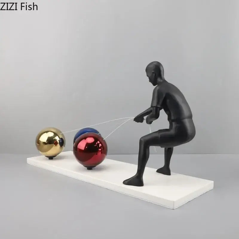 Black glossy resin decorbites abstract character metal sculpture with gold red and blue spheres on white base desk decor