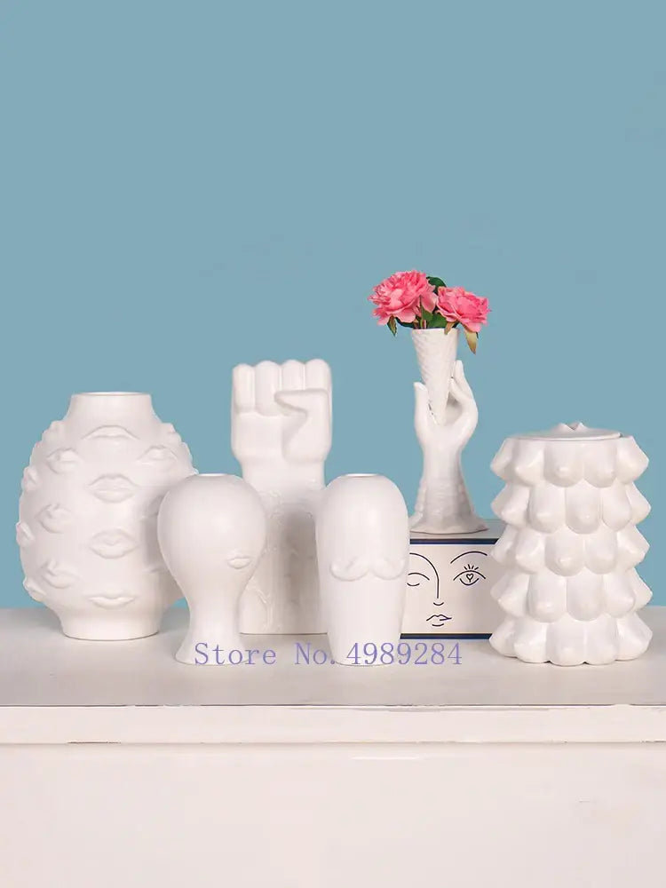 White ceramic vases with sculpted lips fist and faces from decorbites abstract character white ceramics for modern decor