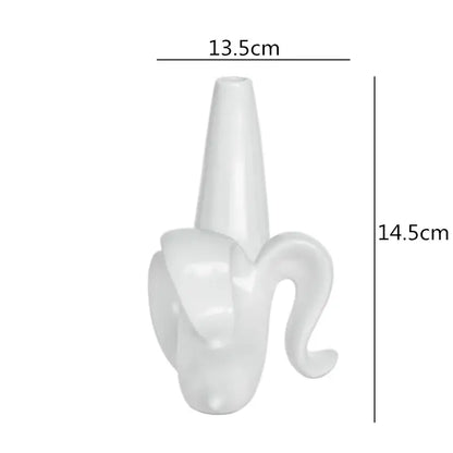 A sleek glossy white ceramic vase shaped like a banana peel for decorbites abstract character home decor