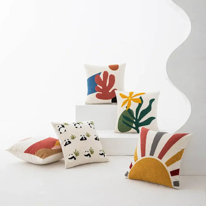 White cushion cover with decorbites abstract embroidery in vibrant green orange blue and red on soft velvet fabric