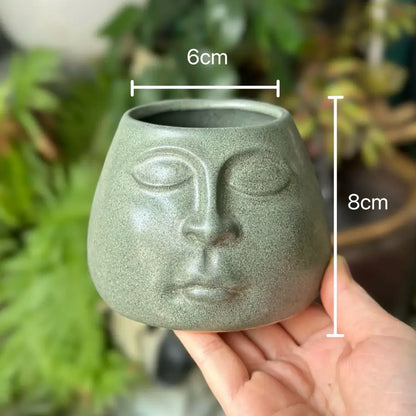 Matte sage green decorbites abstract face ceramic planter with closed eyes for flowerpot vase and home decor accessories