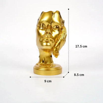 Golden metallic DecorBites™ abstract face mask resin statue with melting effect for elegant home decor use