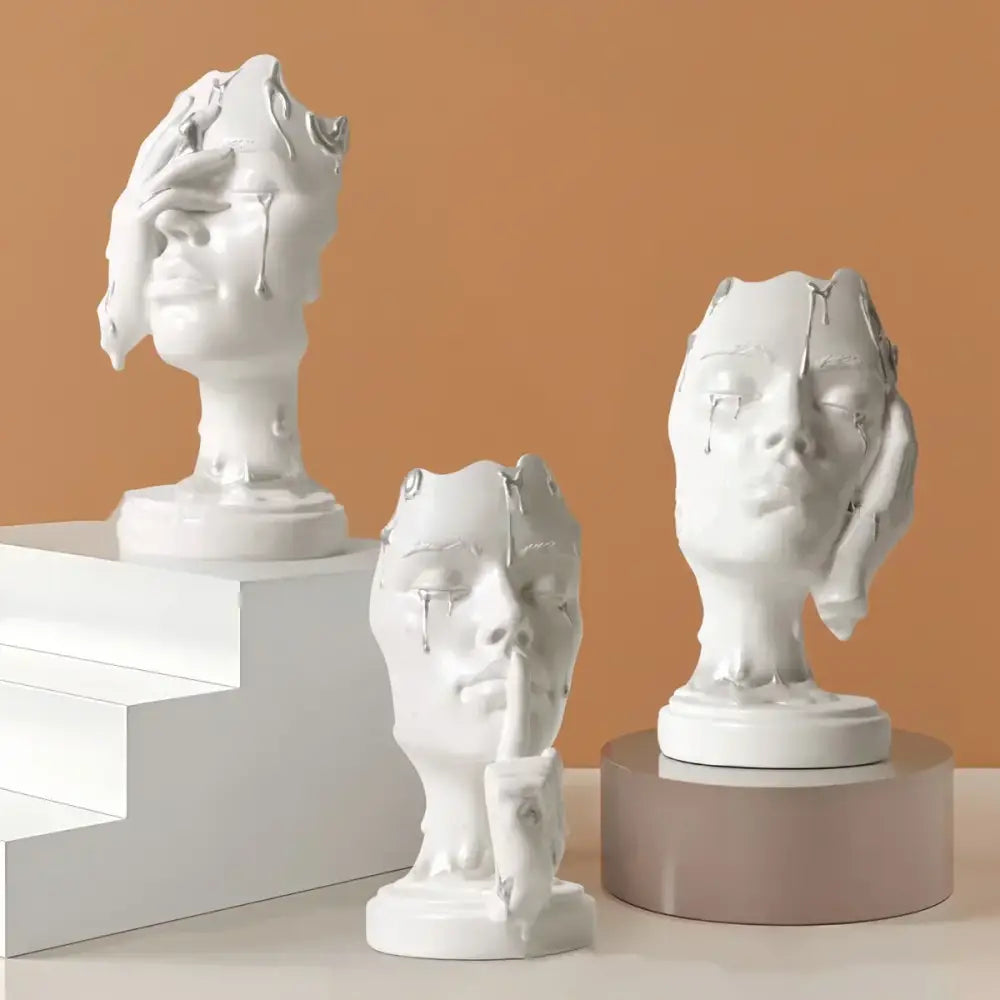 Three white ceramic busts with abstract melting faces and silver accents decorbites abstract face mask home decor statues