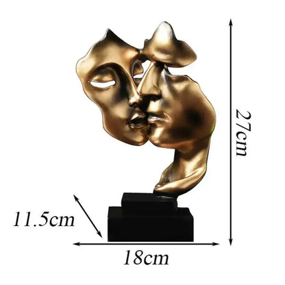 Golden metallic abstract face sculpture of two faces kissing mounted on a black base decorbites face sculpture ornament