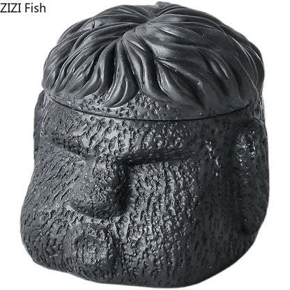 Black ceramic jar shaped like a man’s head with textured features used as portraits cement ashtray by DecorBites™