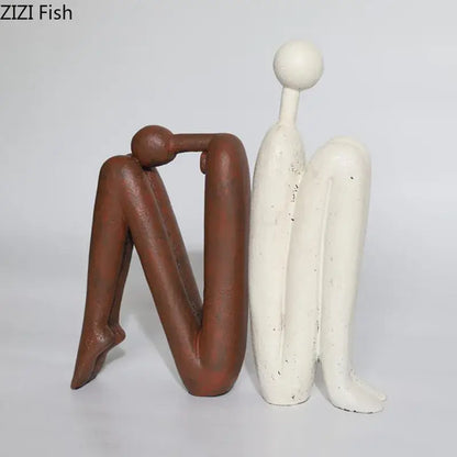 Two matte brown and off-white speckled resin sculptures of decorbites abstract figure desk decor for modern home