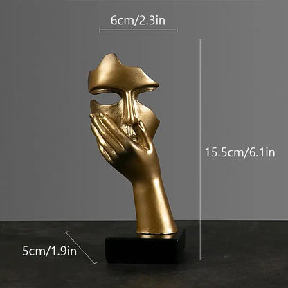 Golden metallic abstract figurines face sculpture with hand covering mouth on black base decorbites abstract figurines
