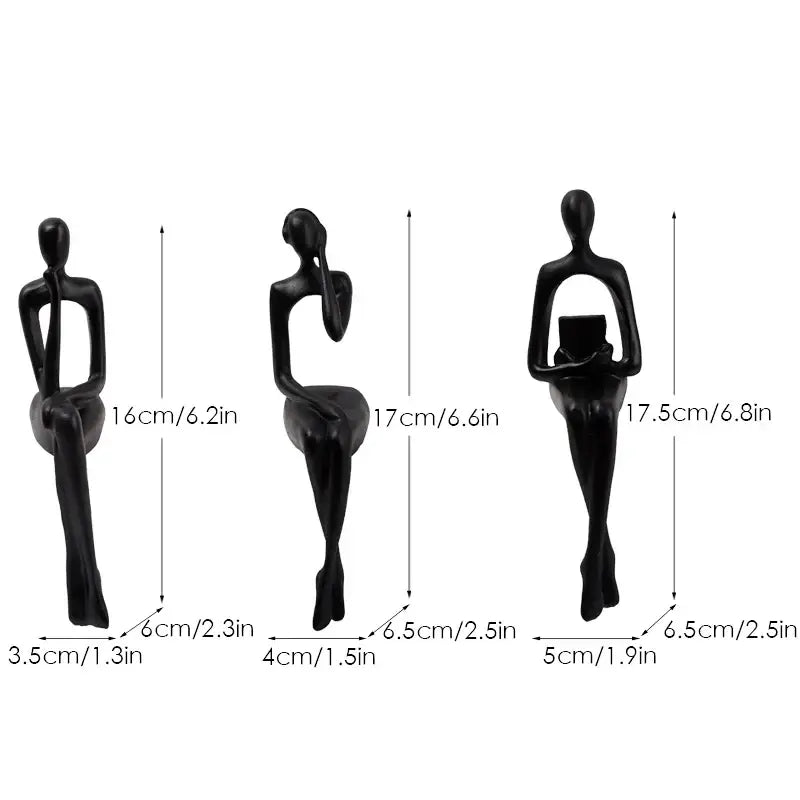 Set of three black decorbites abstract figurines with smooth glossy finish in minimalist seated human form for home and office