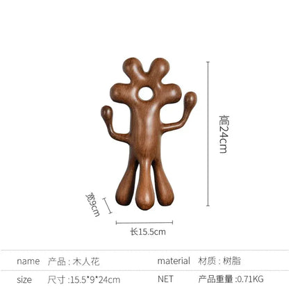 A smooth brown wooden decorbites abstract flower man sculpture with rounded limbs for home decor use