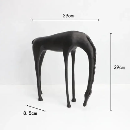Black matte-finished giraffe-shaped side table with slender legs and sleek minimalist design for decorbites abstract horse iron decor
