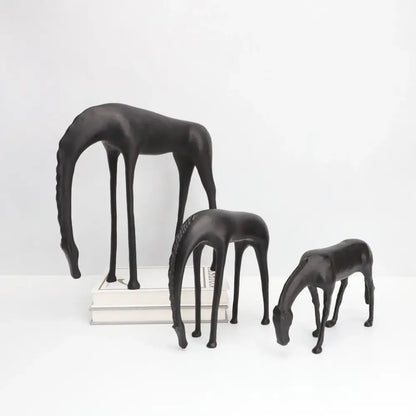 Set of three sleek black resin horse iron sculptures with elongated legs and stylized manes by Decorbites abstract horse
