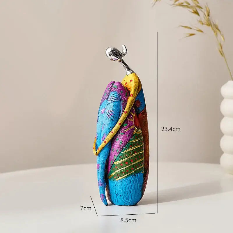 Vibrant decorbites abstract woman sculpture featuring colorful patterned figurines embracing in stylized living room decor