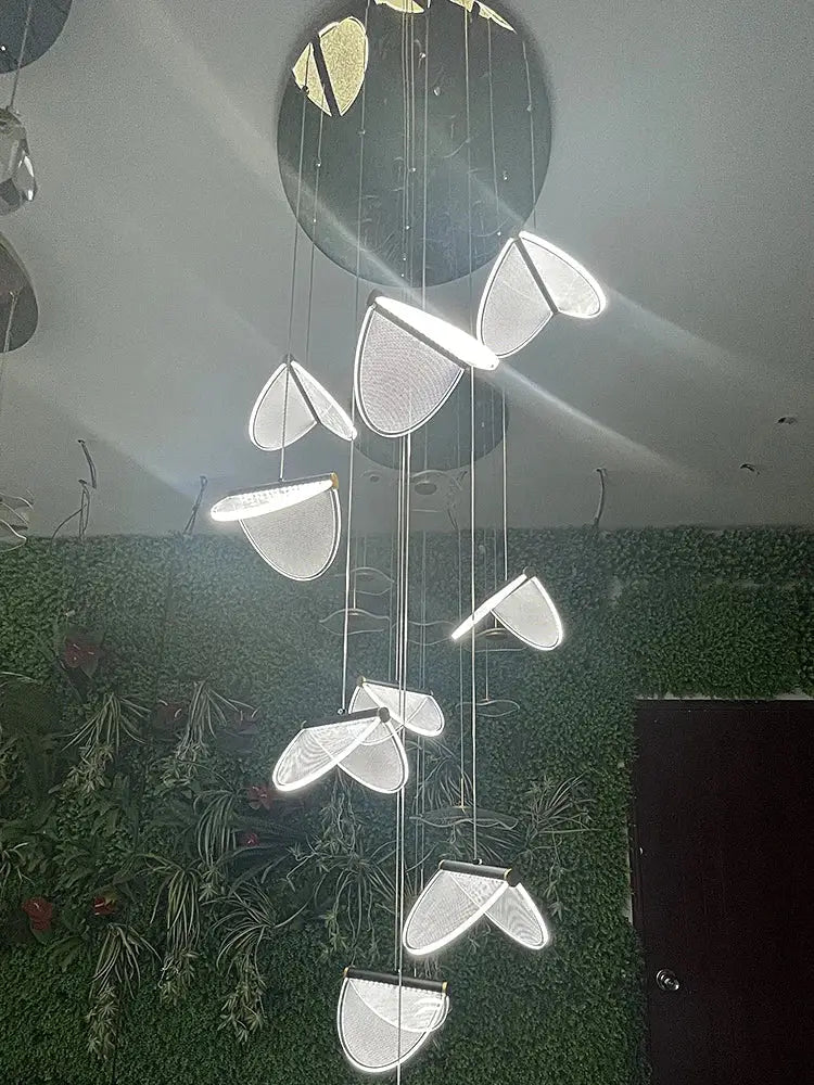 A modern circular acrylic blade stair chandelier with translucent mesh semi-circular lights for cafes and villas