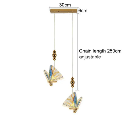 Gold-toned acrylic butterfly chandelier ceiling lamp with iridescent blue and white wings for indoor lighting