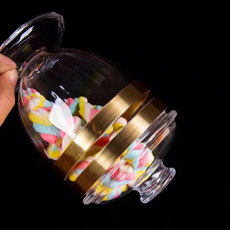 Clear glass acrylic candy jar with gold-toned metallic bands from the decorbites spice jar set for kitchen storage