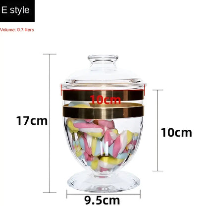 Clear glass acrylic candy jar with gold-toned bands and lid filled with colorful marshmallows from DecorBites™ spice jar set
