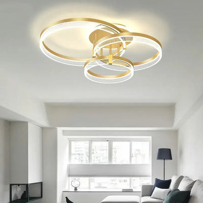 Gold-toned acrylic circle chandelier pendant light with interlocking rings and integrated LED for modern indoor decor