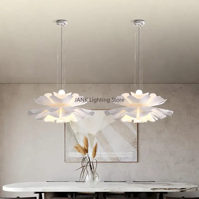 Two elegant white acrylic flower chandelier pendant lights with layered petals and glowing centers for dining and bedroom decor