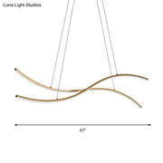 Modern gold-toned acrylic linear island pendant lighting with sleek curved arms and minimalist design for kitchen islands