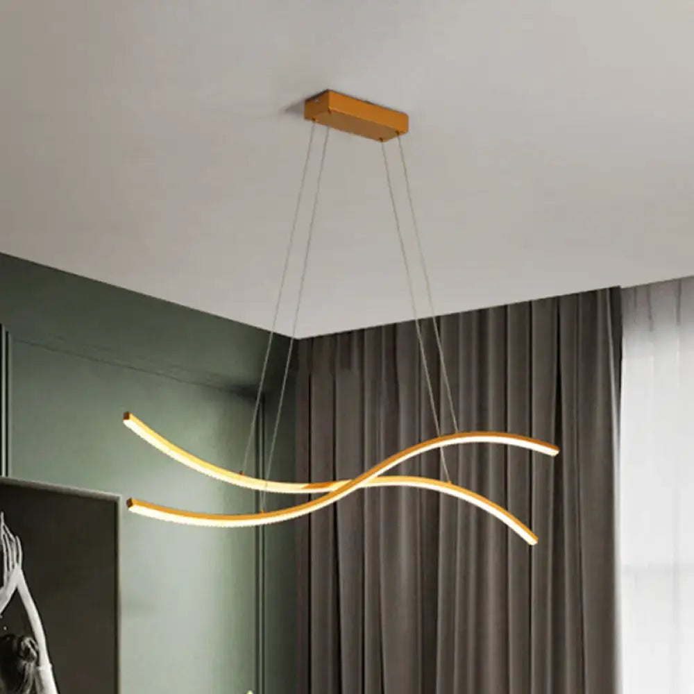 Modern gold-toned linear island pendant with sleek curved arms and rectangular wooden ceiling mount for island pendant lighting