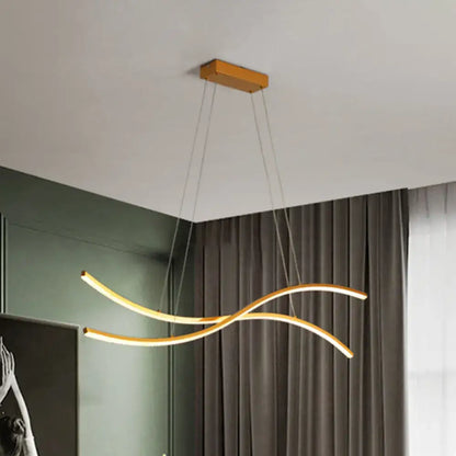 Modern gold-toned linear island pendant with sleek curved arms and rectangular wooden ceiling mount for island pendant lighting