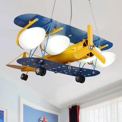 DecorBites airplane chandelier kids led light fixture shaped like a yellow and blue biplane with white globe lamps