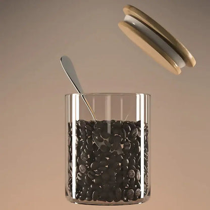 Decorbites airtight glass coffee bean storage jar with clear glass body bamboo lid and silver spoon inside