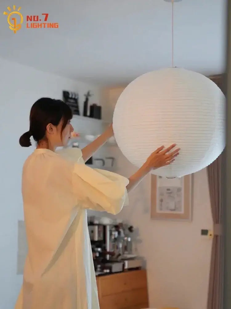 White spherical paper lantern pendant light featuring akari noguchi led design for living room decor by decorbites