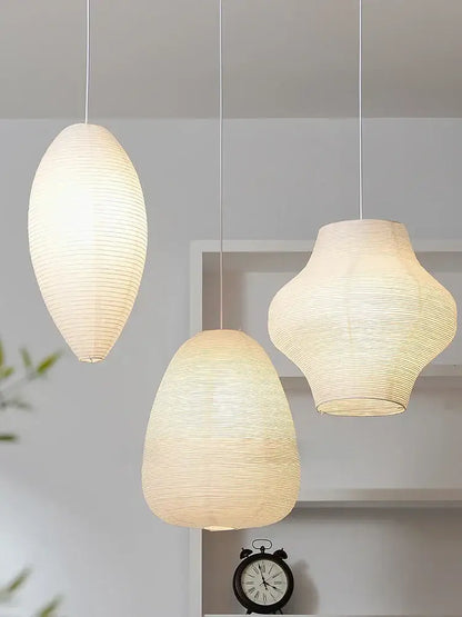 Three elegant off-white decorbites™ akari noguchi rice paper pendant lights with ribbed textures for bedroom or living room