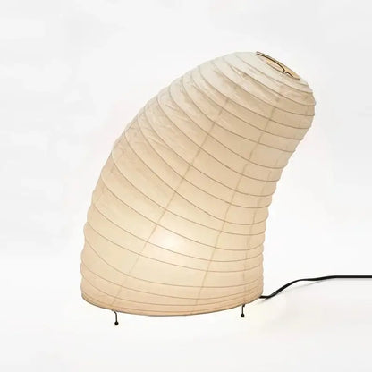 Beige akari noguchi rice paper table lamp with curved ribbed design and black metal legs for modern living room decor