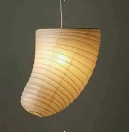 A warm glowing natural beige akari rice paper pendant lamp with curved ribbed design for living room and bedroom lighting