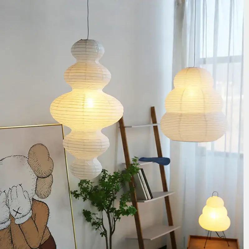 Off-white akari rice paper pendant lamp with tiered design and warm glow for living room and bedroom lighting