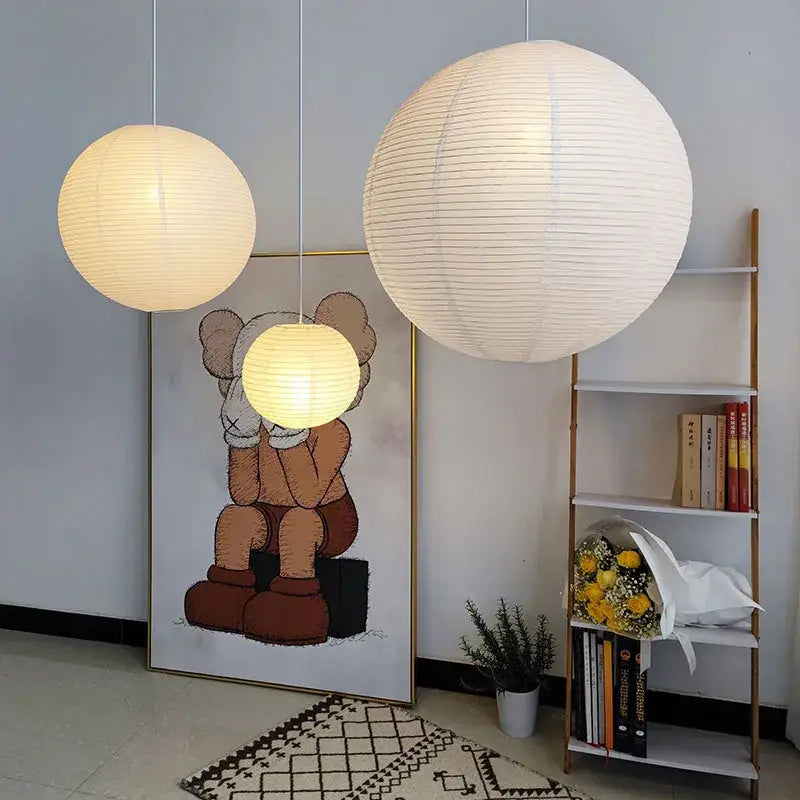 Two spherical white akari rice paper pendant lights glowing warmly and softly for elegant home décor lighting