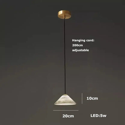 A modern alabaster pendant light with gold ceiling mount, black cord, and frosted white glass shade for living room