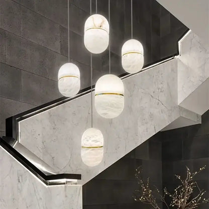 Elegant white marble alabaster pendant lights with gold accents in a modern chandelier for living room decor