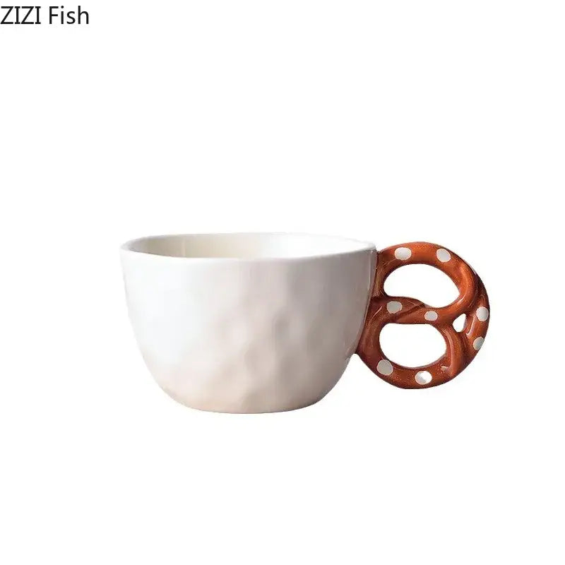 White ceramic biscuit mug ceramic teacup with a brown pretzel-shaped alkali water biscuit handle with white polka dots